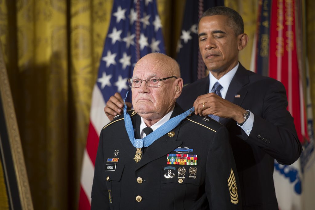 President Barack Obama bestows the Medal of Honor to retired Command Sgt. Maj. Bennie G. Adkins in the East Room of the White House, Sept. 15, 2014.  Adkins distinguished himself during 38 hours of close-combat fighting against enemy forces on March 9 to 12, 1966.  At that time, then-Sgt. 1st Class Adkins was serving as an Intelligence Sergeant with 5th Special Forces Group, 1st Special Forces at Camp "A Shau", in the Republic of Vietnam.  During the 38-hour battle and 48-hours of escape and evasion, Adkins fought with mortars, machine guns, recoilless rifles, small arms, and hand grenades, killing an estimated 135 - 175 of the enemy and sustaining 18 different wounds.  (U.S. Army photo by Staff Sgt. Bernardo Fuller/Released)